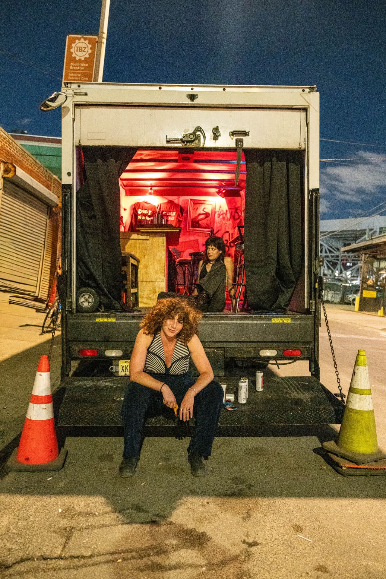 The truck, back open, interior lit red