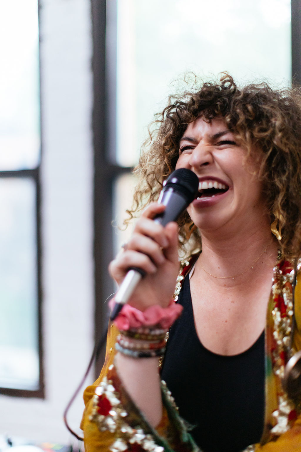 On the mic — mid-laugh