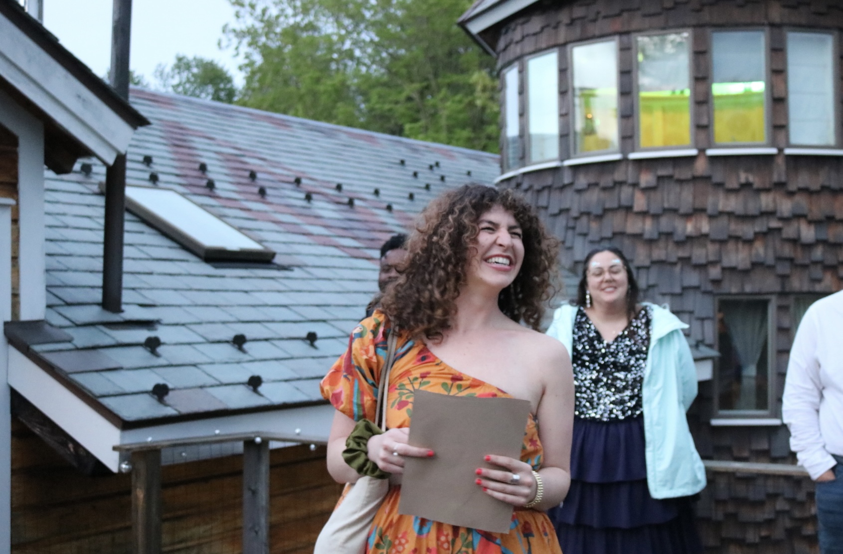 Kate Russell laughing with a group on a rooftop retreat